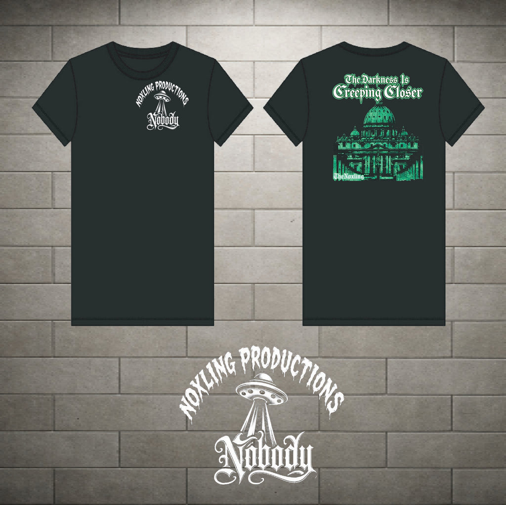 Two black short-sleeve t-shirts shown front and back against a gray brick wall background. The front shirt has a small white circular graphic on the left chest reading 'Noxling Productions Nobody'.