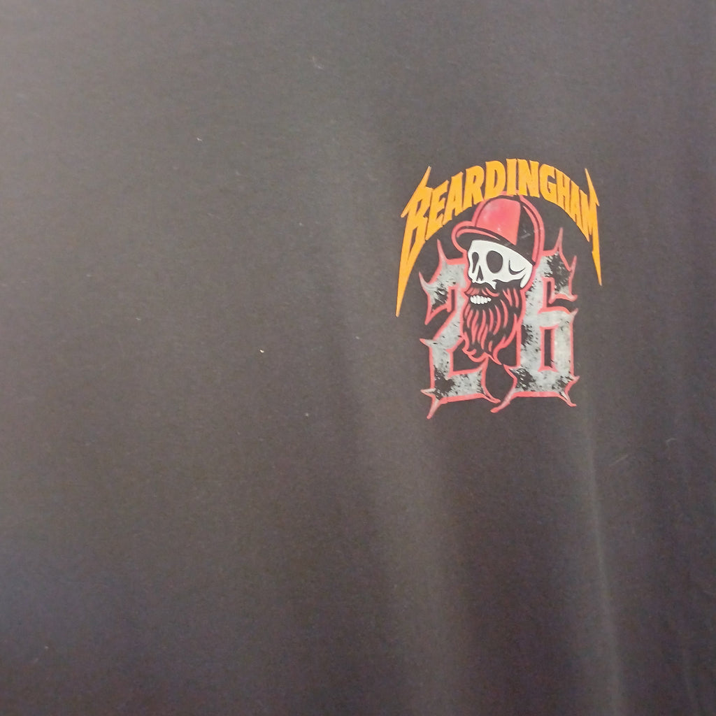 Close-up of a black t-shirt featuring a graphic print on the chest with a skull in a red cap, the word 'Beardings' in yellow, and the number '26' in red and white.