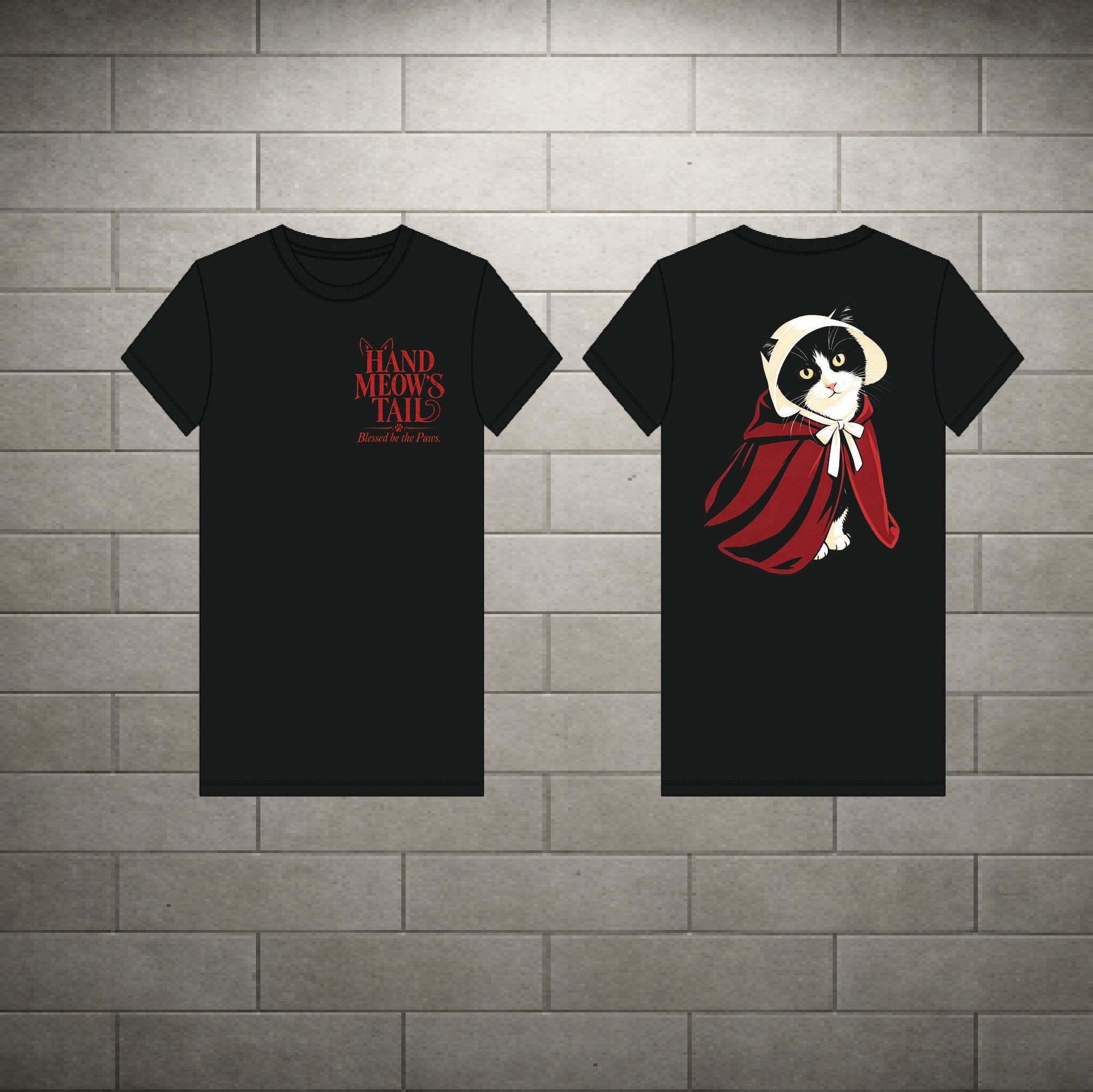 Two black short-sleeve T-shirts displayed against a gray brick wall background, showing the front and back designs. The front shirt features red text reading 'A Hand-Made's Tale' with smaller text below.