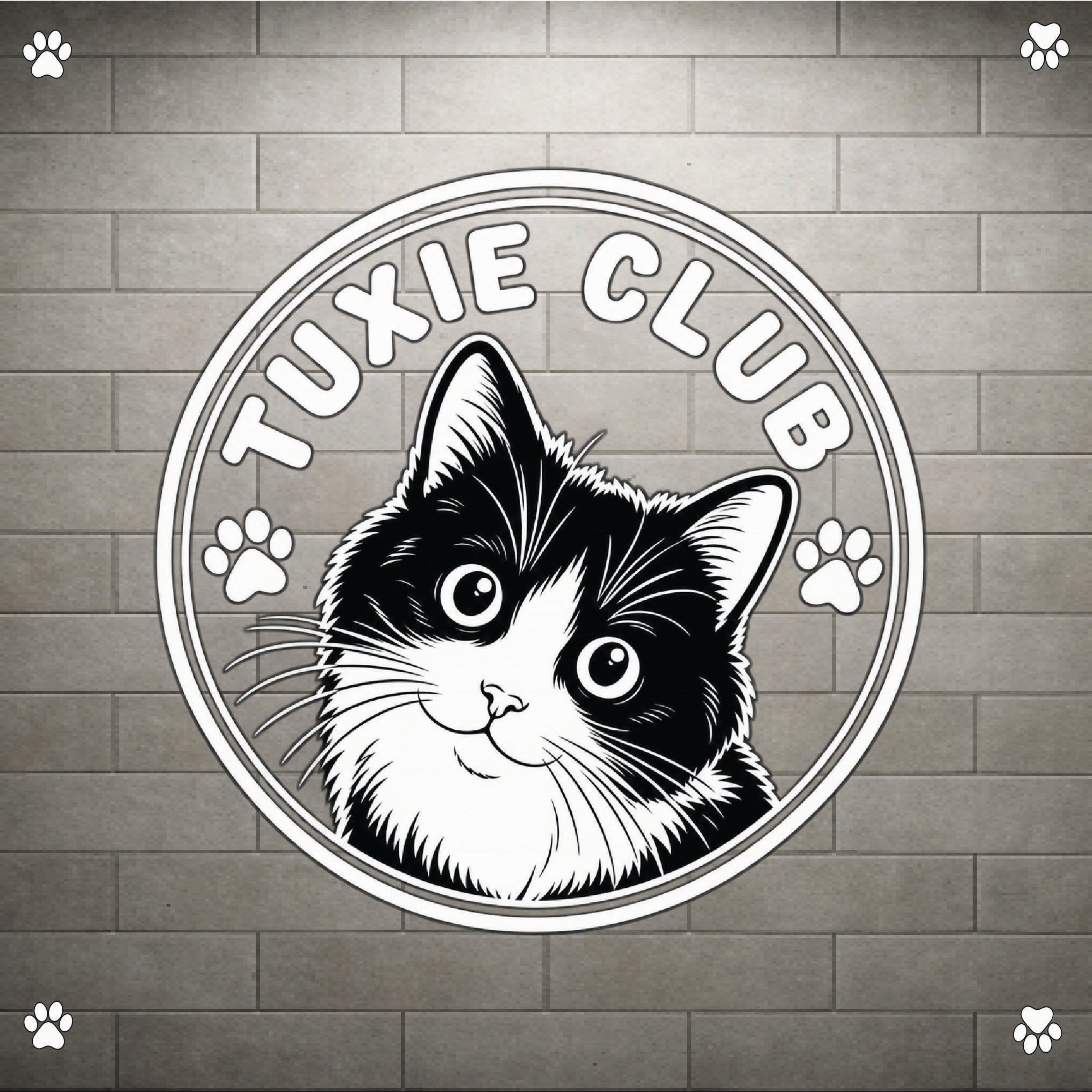 A circular black and white graphic featuring a tuxie cat illustration with the text 'TUXIE CLUB' and paw prints, shown on a gray brick wall background with small paw icons in the corners.